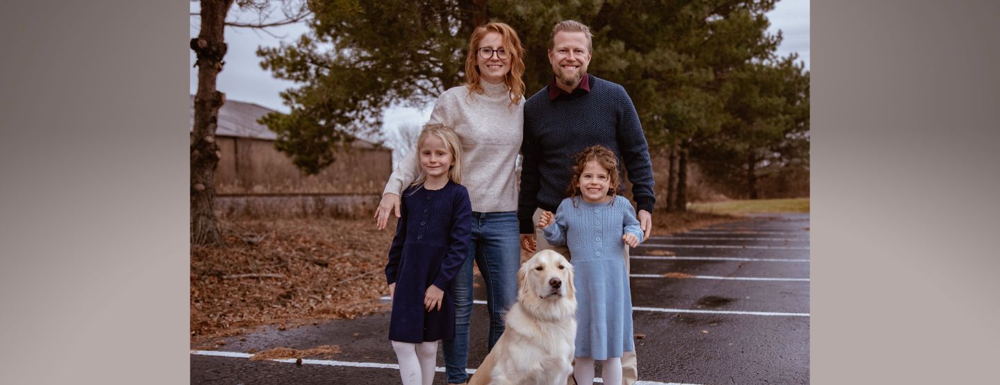 Dr. Schenk and family smile at the camera. 