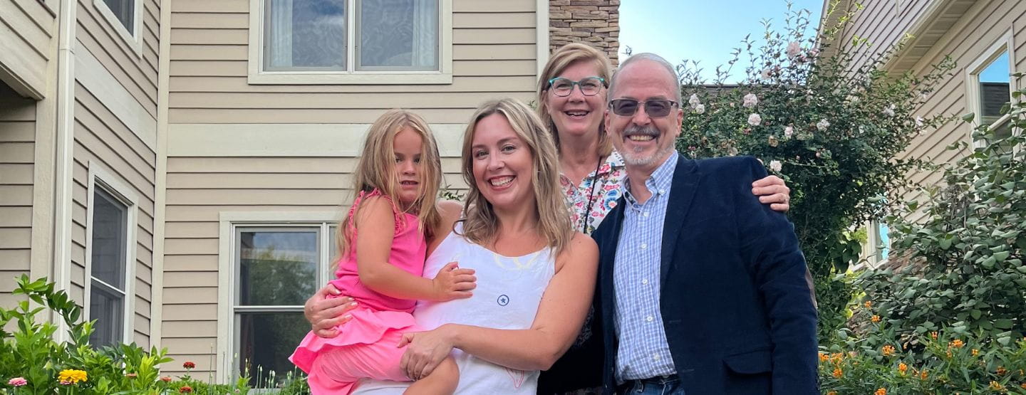 Dr. Camick smiles at the camera with family.