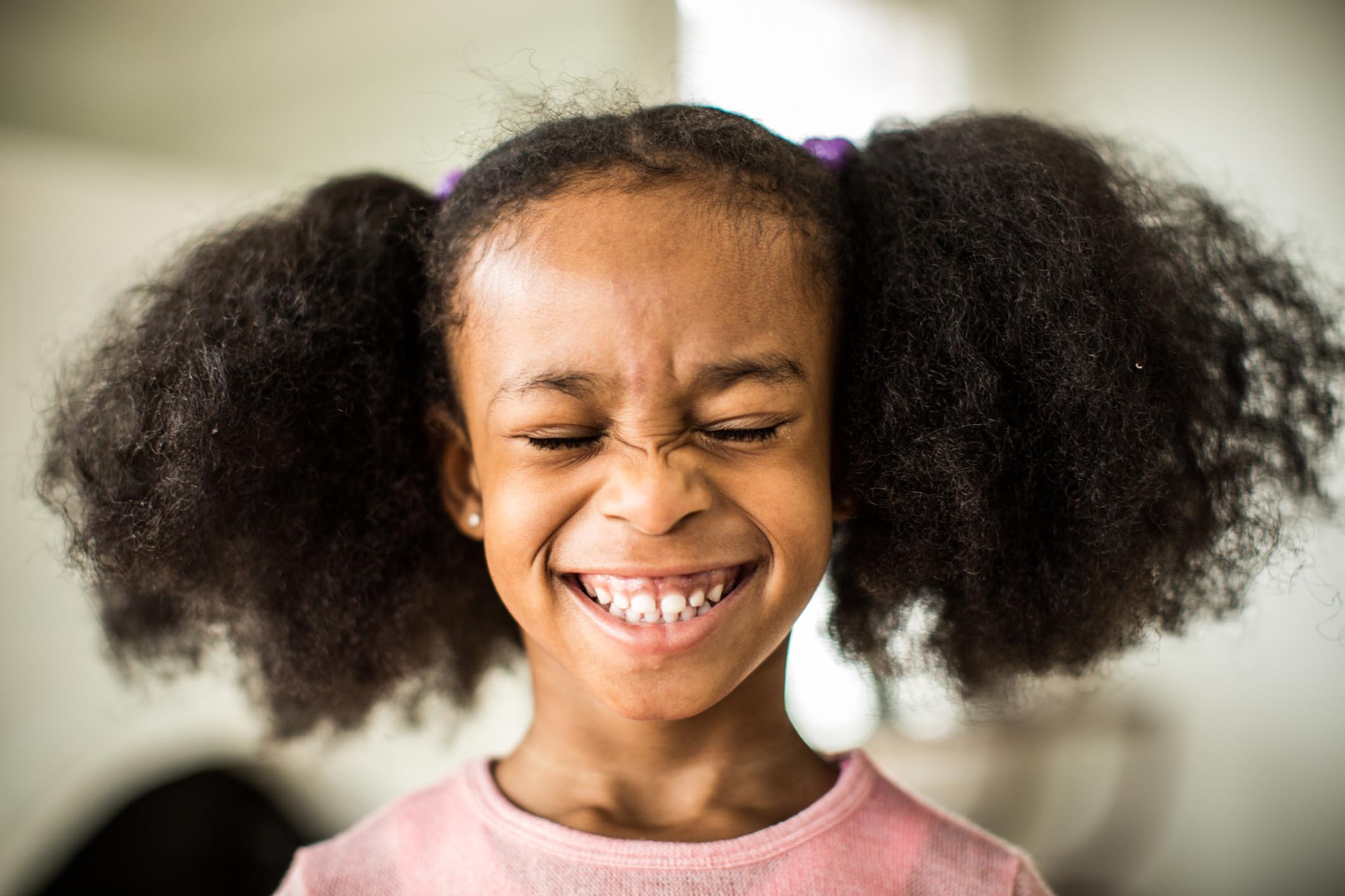 A little girl smiling.