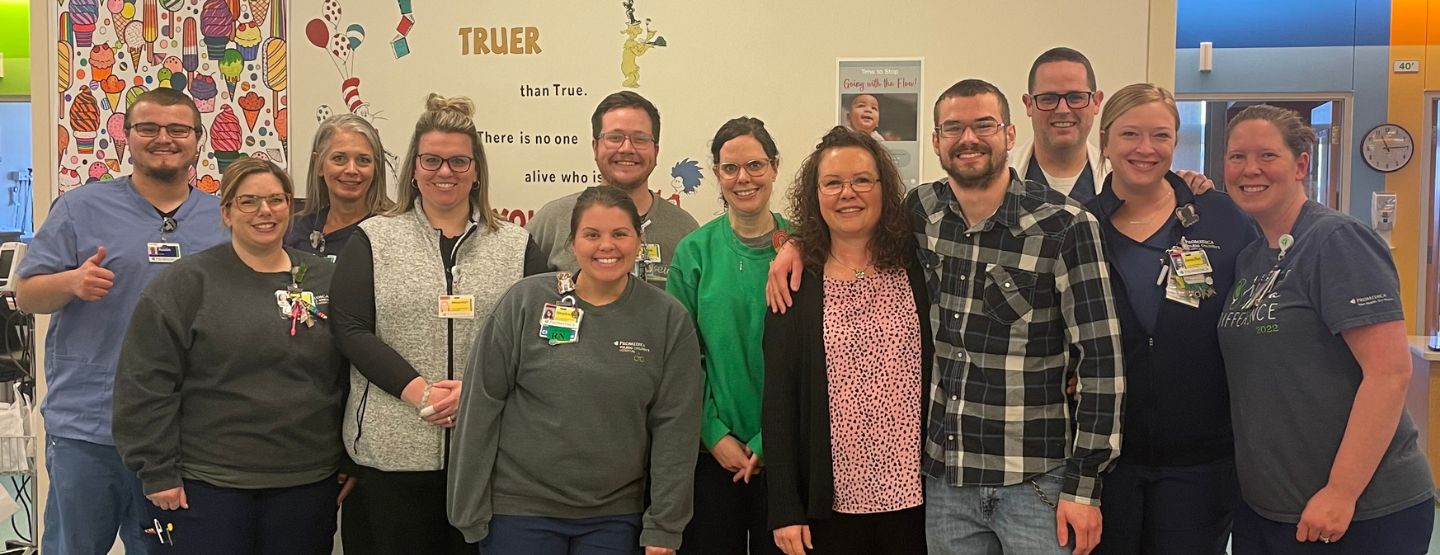 Jen and David Burkhart posing with the PICU care team.