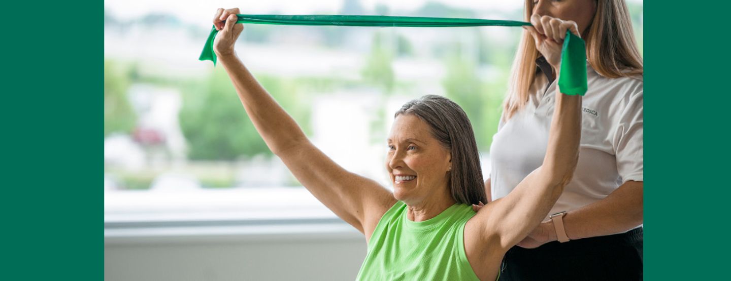 Woman doing arm exercise with resistance band.