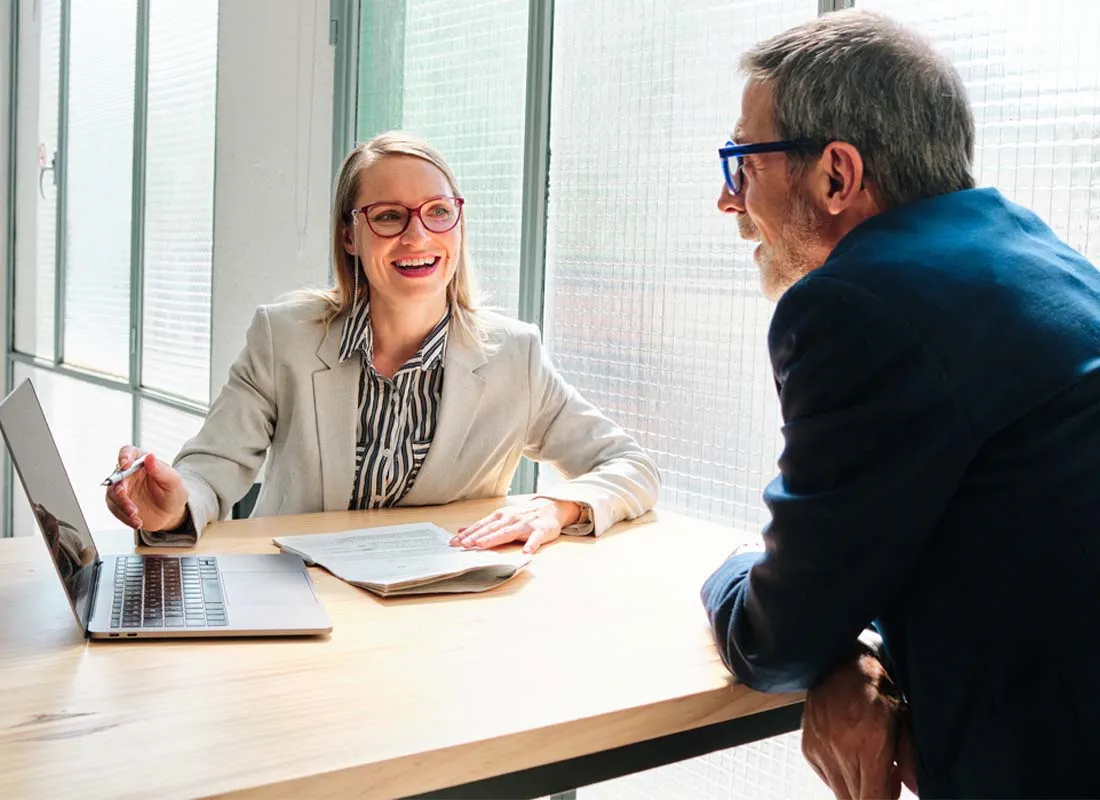 an insurance broker meets with a client in her office