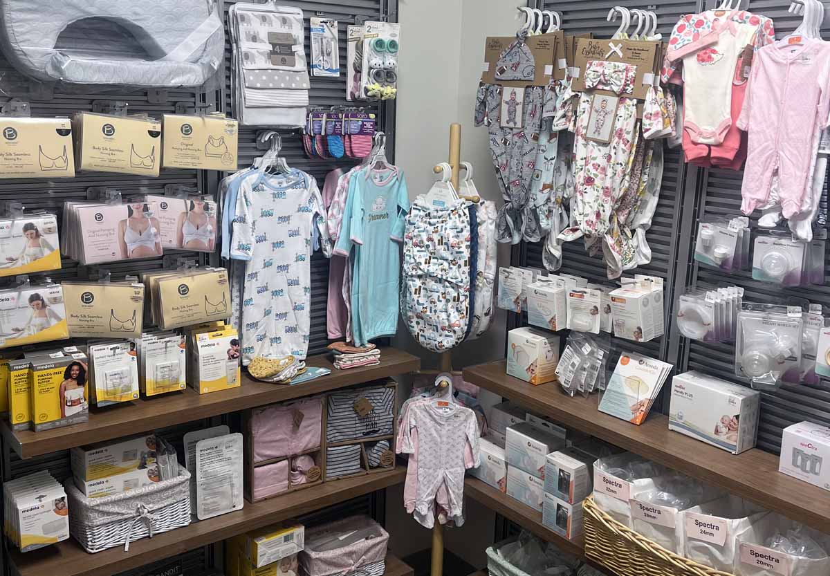 interior shelves at the Mom and Me Boutique, filled with items such as nursing bras, baby onesies, and other accessories for infants