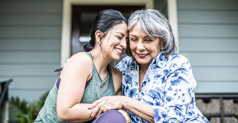  A mother and daughter hug outside and discuss vascular treatment methods