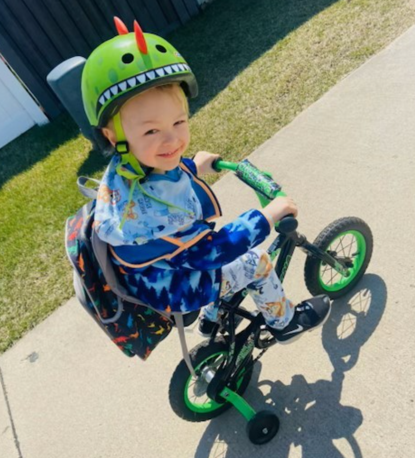 Charley Myers rides his bicycle outdoors