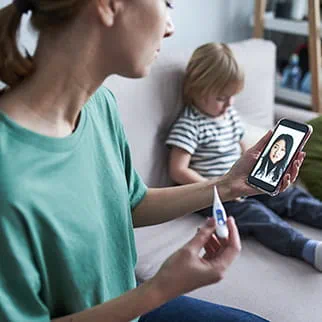 A parent holds a thermometer 
