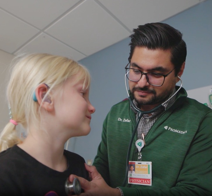 doctor checking on girl 