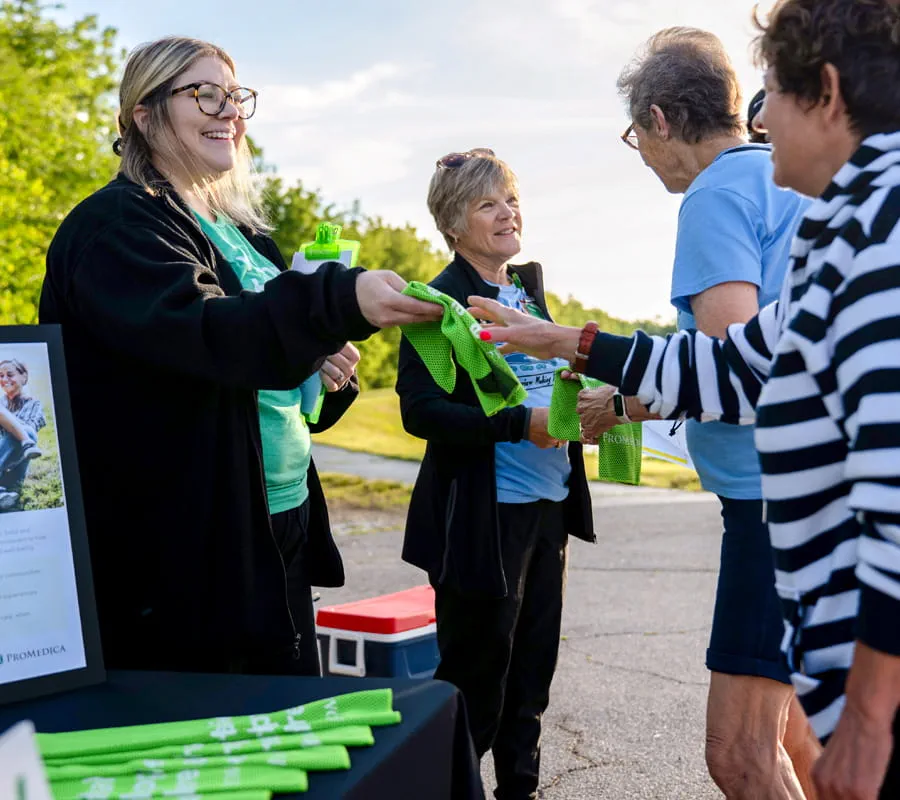 Woman handing out cooling towels